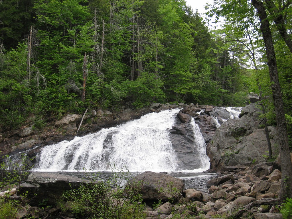 Old Hill Village - South End 550.jpg - In February 1937, residents of Hill Village NH learned that their village, near the Pemigewasset River, was to become a flood control reservoir for the Franklin Falls dam project. To accommodate the construction of the Franklin Falls Dam, the village of Hill NH was to be relocated. By January of 1940, the citizens of Hill NH formed an association, purchased land, and began planning a new model village with the help of the NH State Planning and Development Commission. Construction started in 1940, and by June of 1941 the new town hall and school were completed, along with the streets, water system, and 30 houses. The 1941 town meeting was called to order in the old town hall, recessed, and reconvened in the new village.